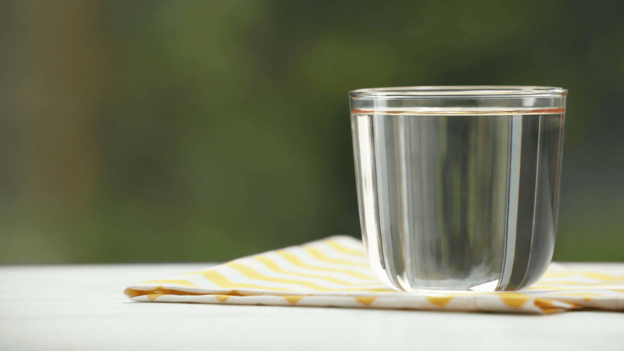 Glass of clean, pure water illustrating home water filtration system benefits.