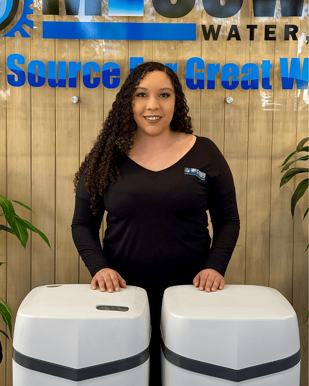 Monique, scheduling manager at McCowin Water, in front of water treatment equipment