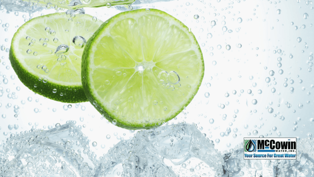 Sliced lime submerged in clear, bubbling water with McCowin Water logo; symbolizing the purity and freshness only a reverse osmosis system can deliver.