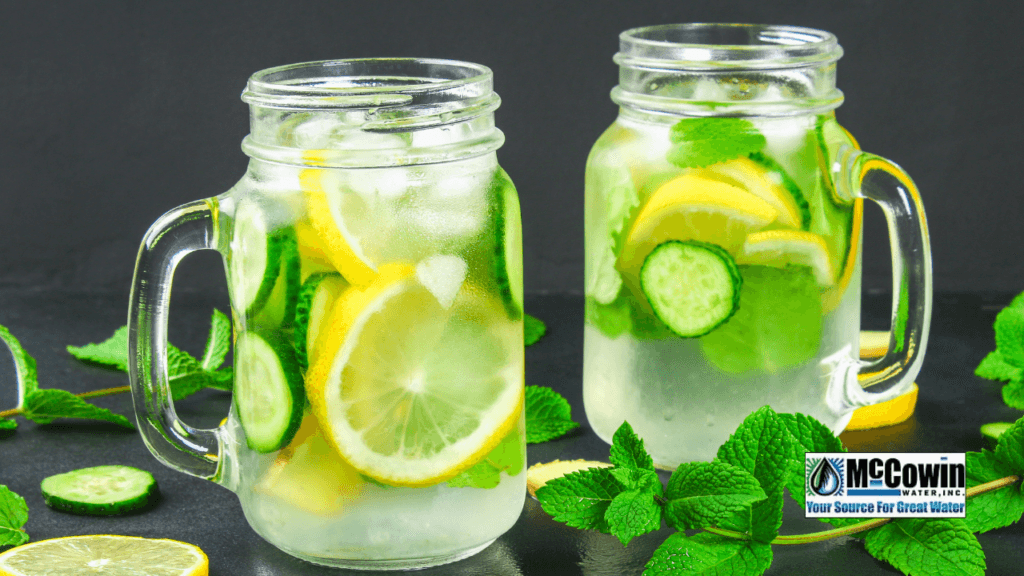 The Water’s Clear… But Is It Clean? What Every Irvine Homeowner Should Know About Water Filtration Two mason jars filled with filtered water, lemon slices, cucumber, and mint, representing clean, refreshing hydration with McCowin Water in Irvine.