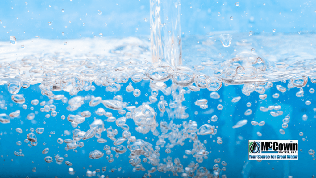 Deep Research Report: Water Filtration Systems for Better Drinking Water Quality in Irvine and Orange County Clean filtered water with air bubbles rising, representing purified output from advanced water filtration systems, with McCowin Water logo in bottom corner.