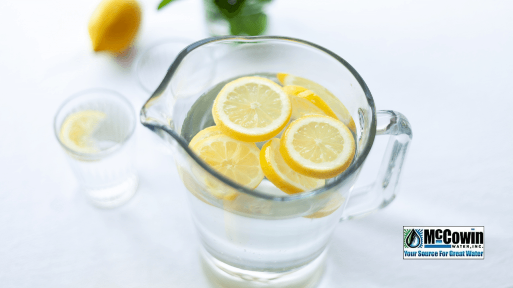 Pitcher of reverse osmosis water with lemon slices on a table, symbolizing clean, healthy hydration provided by McCowin Water in Orange County.