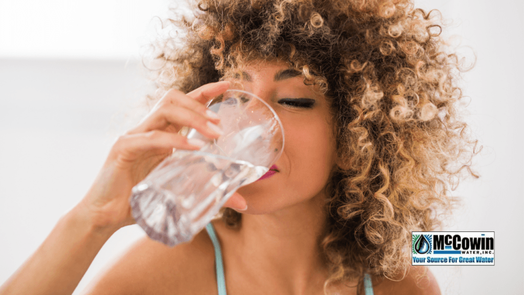 The Whole House Water Filtration System: Why Orange County Homes Can’t Afford to Skip It Woman enjoying a refreshing glass of purified water from a McCowin Water whole house water filtration system in Irvine, CA.