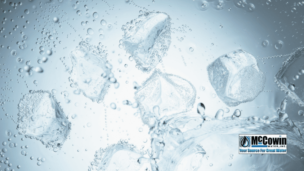 How Do I Know How Hard My Water Really Is? Crystal-clear ice cubes floating in purified water, symbolizing the clarity and purity achieved after testing and treating hard water with McCowin Water in Orange County.