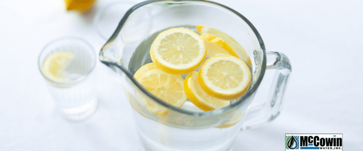 Pitcher of reverse osmosis water with lemon slices on a table, symbolizing clean, healthy hydration provided by McCowin Water in Orange County.