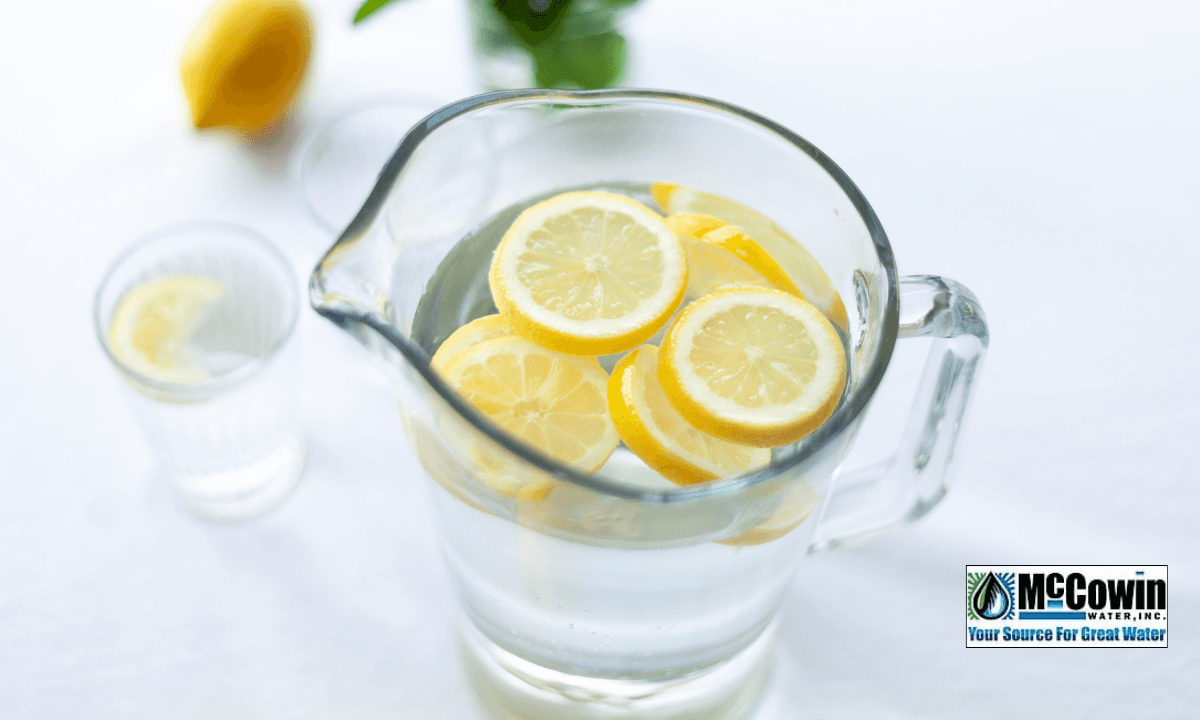 Pitcher of reverse osmosis water with lemon slices on a table, symbolizing clean, healthy hydration provided by McCowin Water in Orange County.